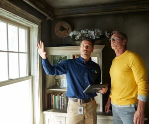 ServiceMaster Restore technician reviewing restoration plan with homeowner