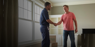 ServiceMaster Restore disaster restoration tech shaking hands with a happy customer